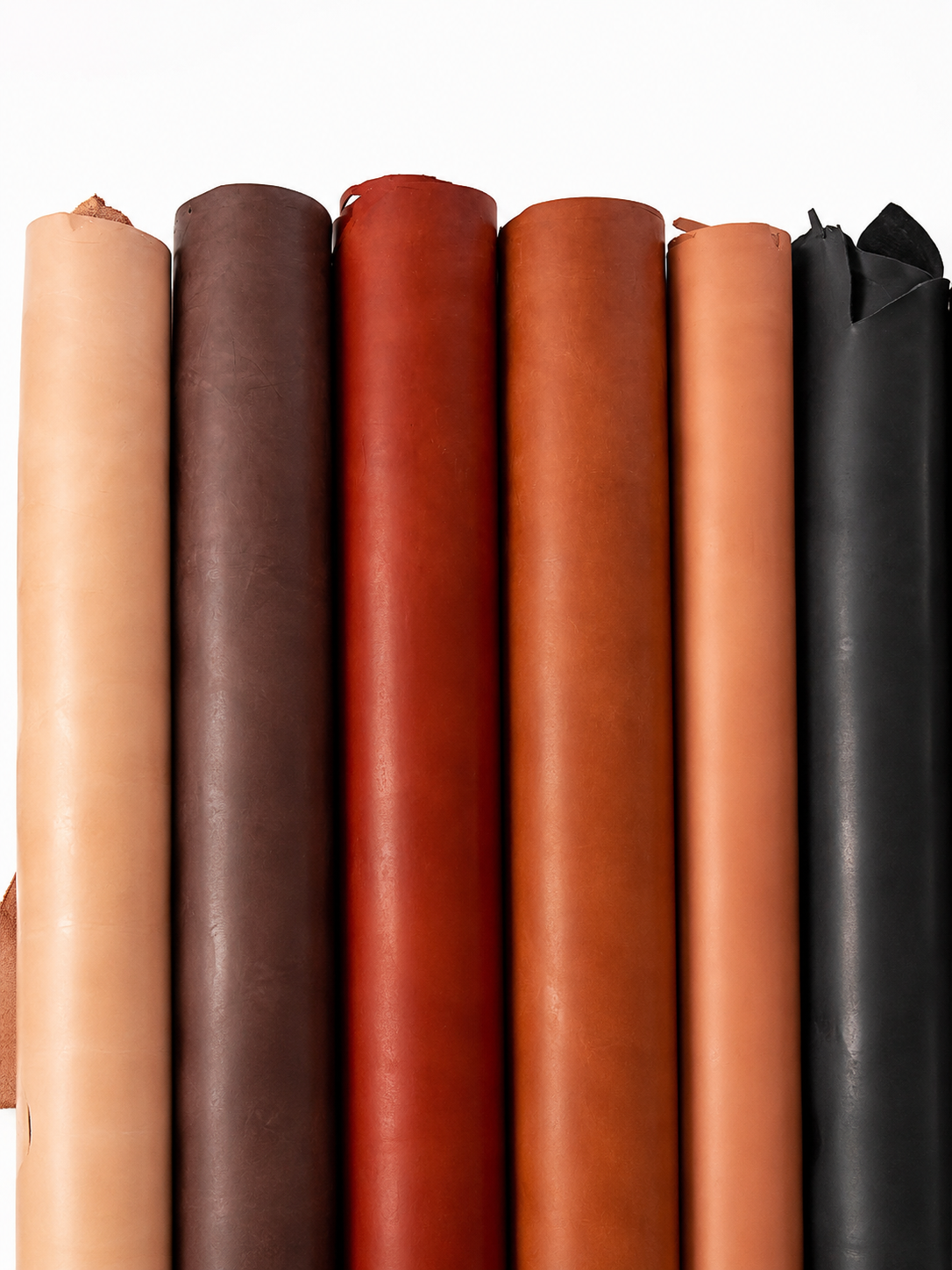 Rolls of leather in natural brown, red and black tones